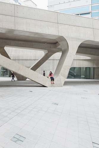 dongdaemun design plaza woman sitting on gray concrete formation during daytime south korea